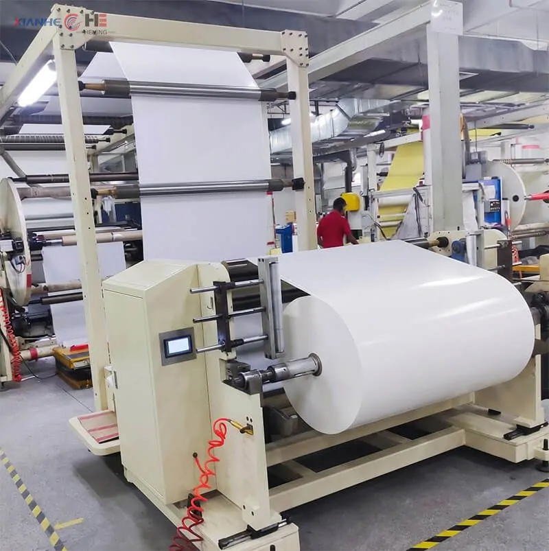 Factory-direct glassine release base paper with custom slitting Super-calendered glassine paper jumbo roll on an industrial slitting machine in a manufacturing facility